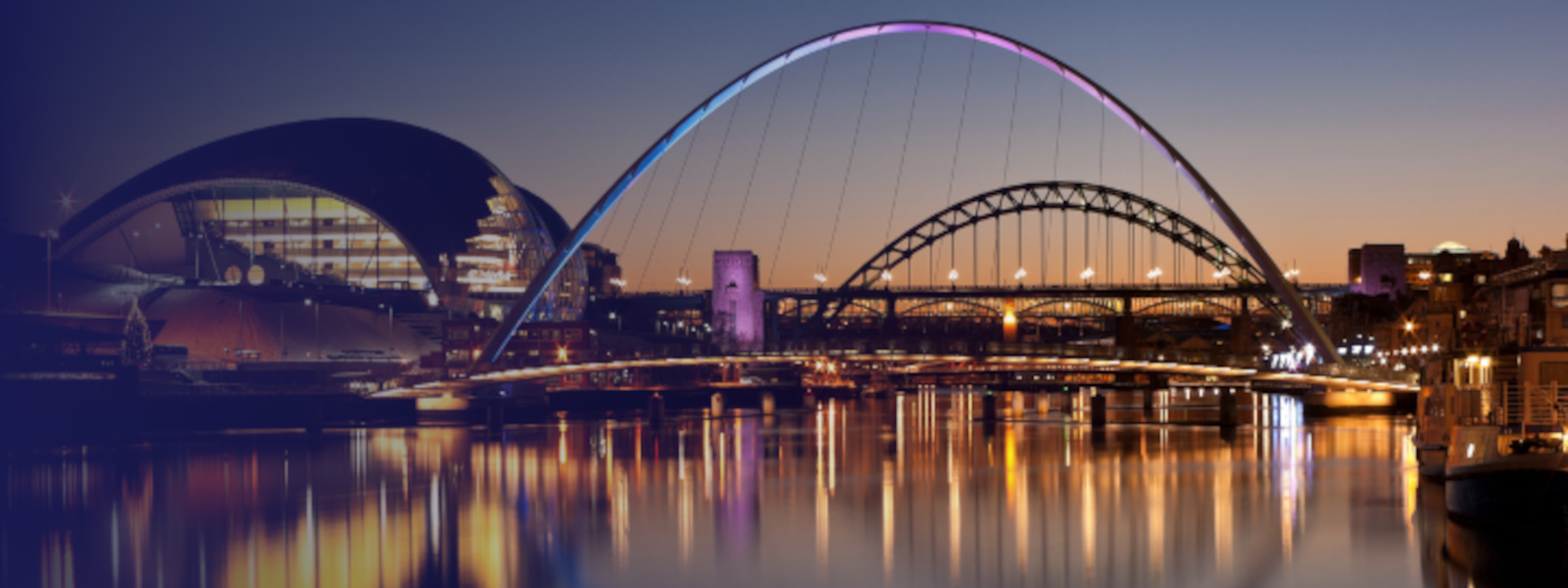 Bridge over river in Newcastle at dusk