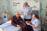 nurses helping a patient in hospital