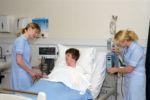 nurses helping a patient in hospital