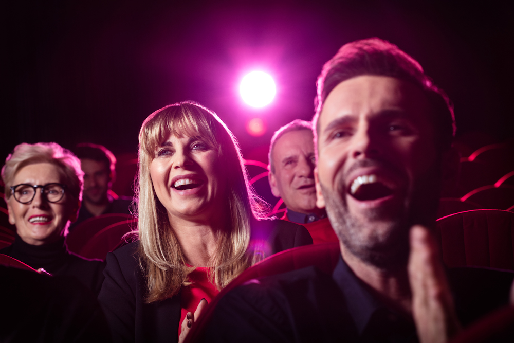 Close-up of audience in cinema laughing