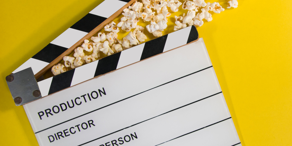 Blank film clapperboard with popcorn flying out
