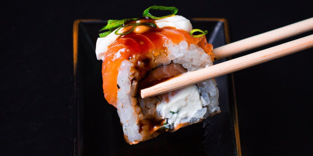 Close up of chopsticks holding a piece of sushi