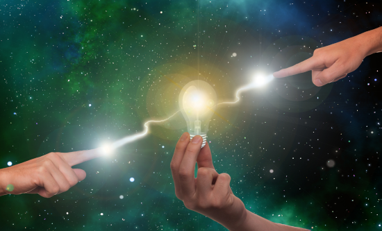 Lightbulb at centre of two pointing hands joined by arc of light