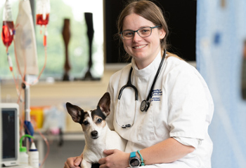 PhD student and their dog in a veterinary lab