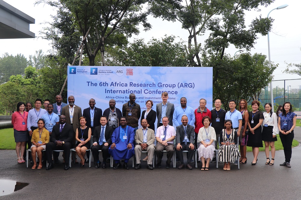 People from the Africa Research Group sat for a formal photo in front of a banner that reads 'The 6th Africa Research Group (ARG) International Conference
