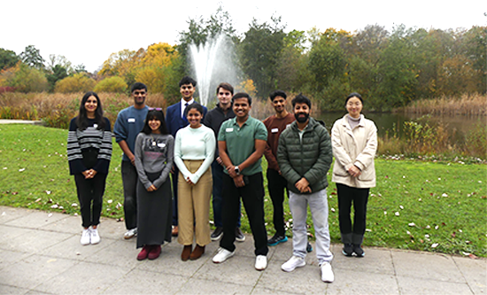 Group of students on the Sustainability and Societal Impact Fellows Programme standing together on path with grass behind them at Jubilee Campus
