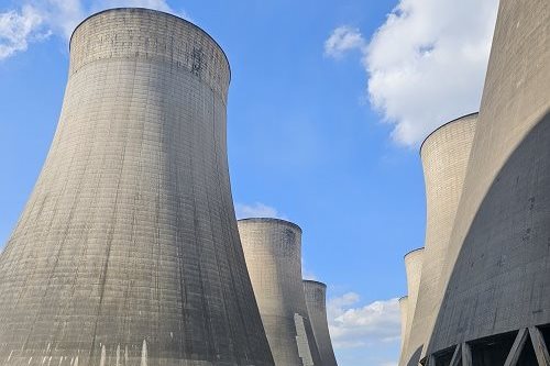 Cooling towers at Ratcliffe-on-Soar power station against a blue sky.
