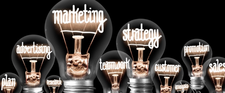 Lightbulbs with words written inside them relating to marketing, eg sales, advertising, marketing.