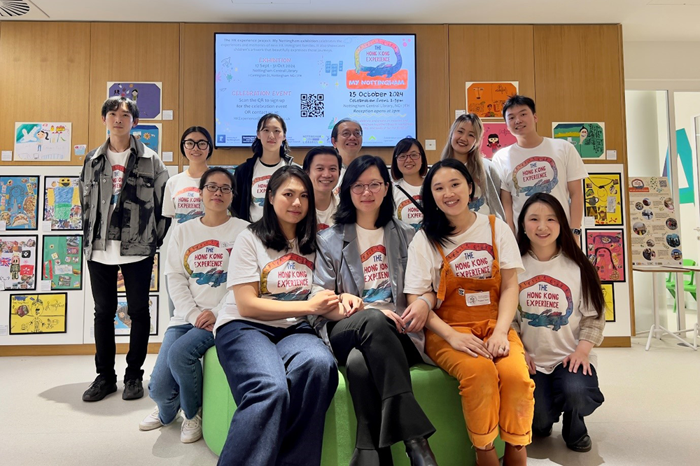 Group photo of students in a classroom each wearing a t-shirt that says 'The Hong Kong Experience' on it.