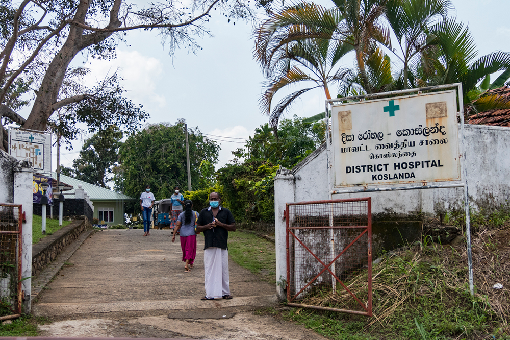 A local man stands by the entrance of a local rural hospital.