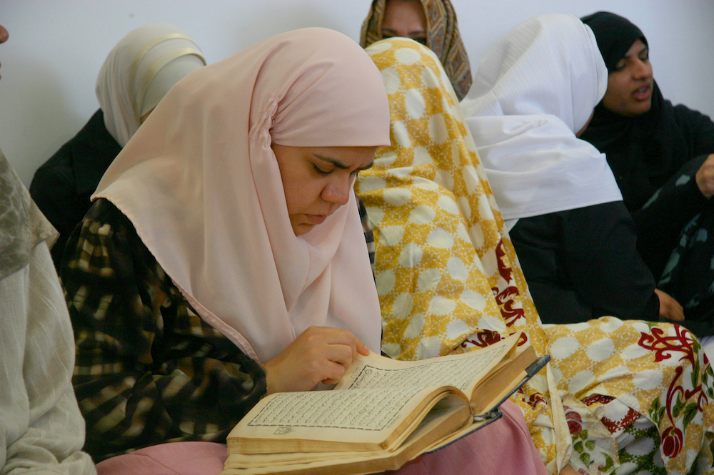 Female Muslim student with a prayer book