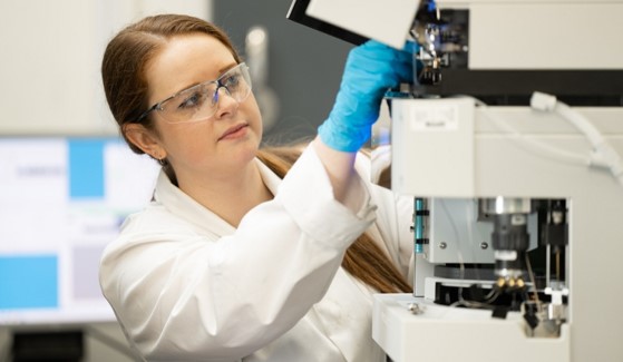 An image of a woman operating a machine