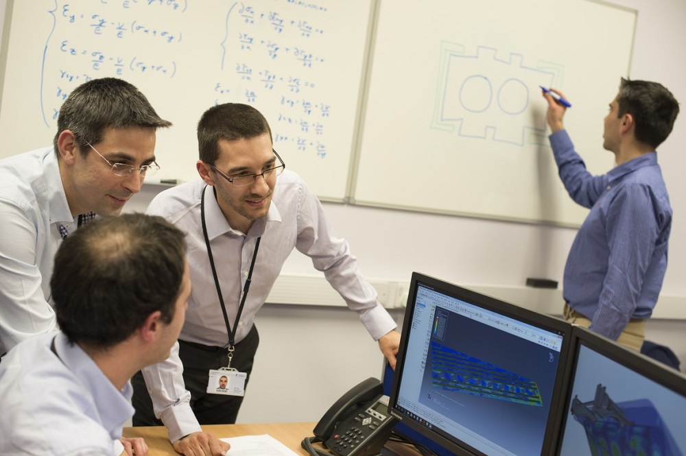 Researchers working out calculations on a whiteboard