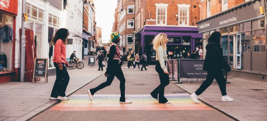 4 students walking across a rainbow crossing in Hockley, Nottingham