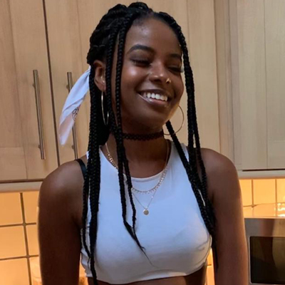 A close-up of Aiesha Wilson, standing in her kitchen and smiling