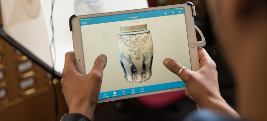 Student holding tablet showing 3D scan of object