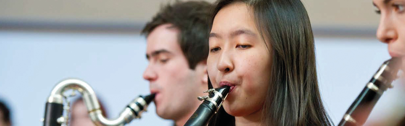 Three people playing oboes
