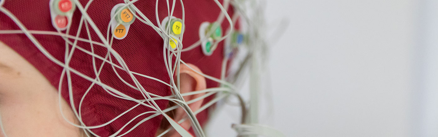 Close up of student wearing skull cap to measure brain activity