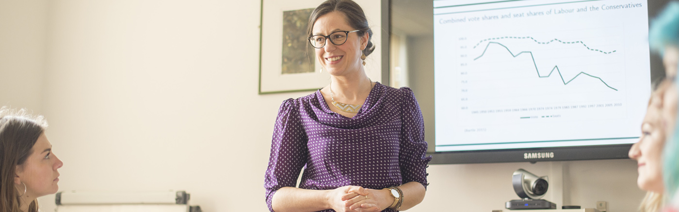 Smiling lecturer in front of class