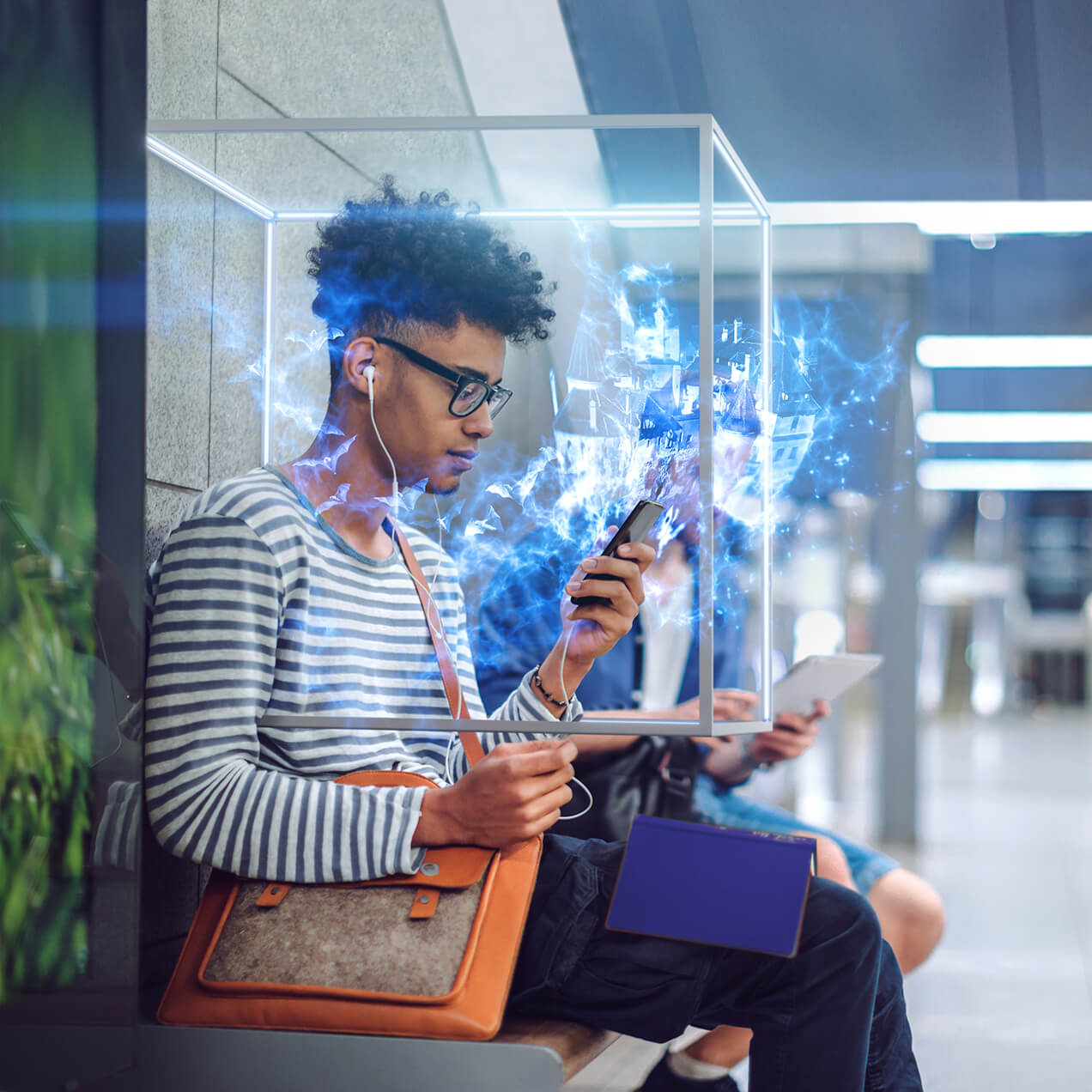 Young man sat outside looking at his phone, with a cube grahpic surrounding him