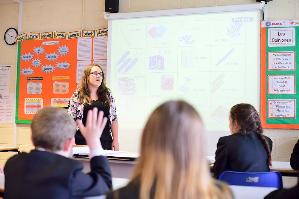 Female modern languages teacher in classroom with pupils