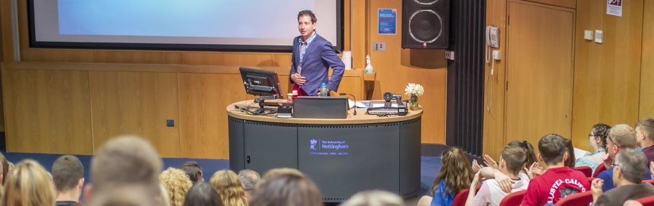 Image of a lecture taking place, as viewed from the audience