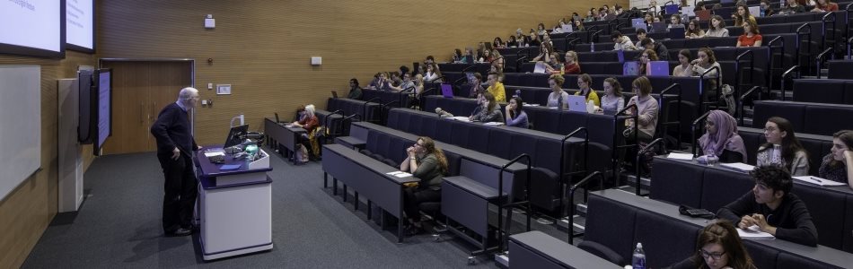 Image of a lecture taking place in the main lecture theatre of the Monica Partridge Building