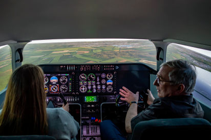 aerospace student and staff in flight simulator