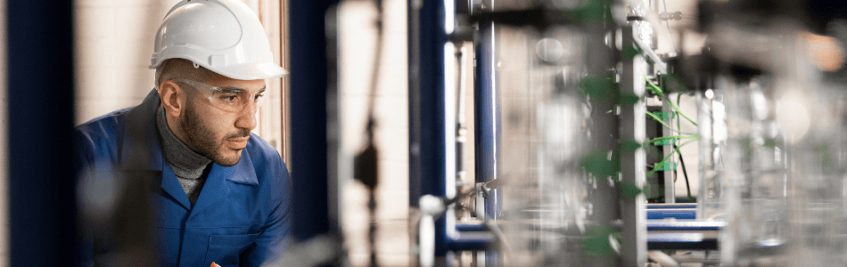 Technician working on a Batch Distillation Column rig