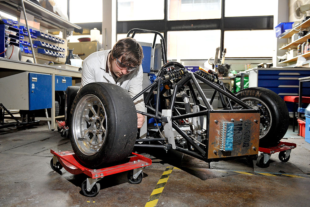 Student working on a car