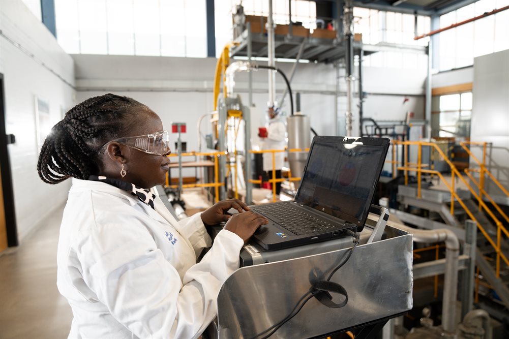A PhD student using an inclinable rig in an engineering workshop