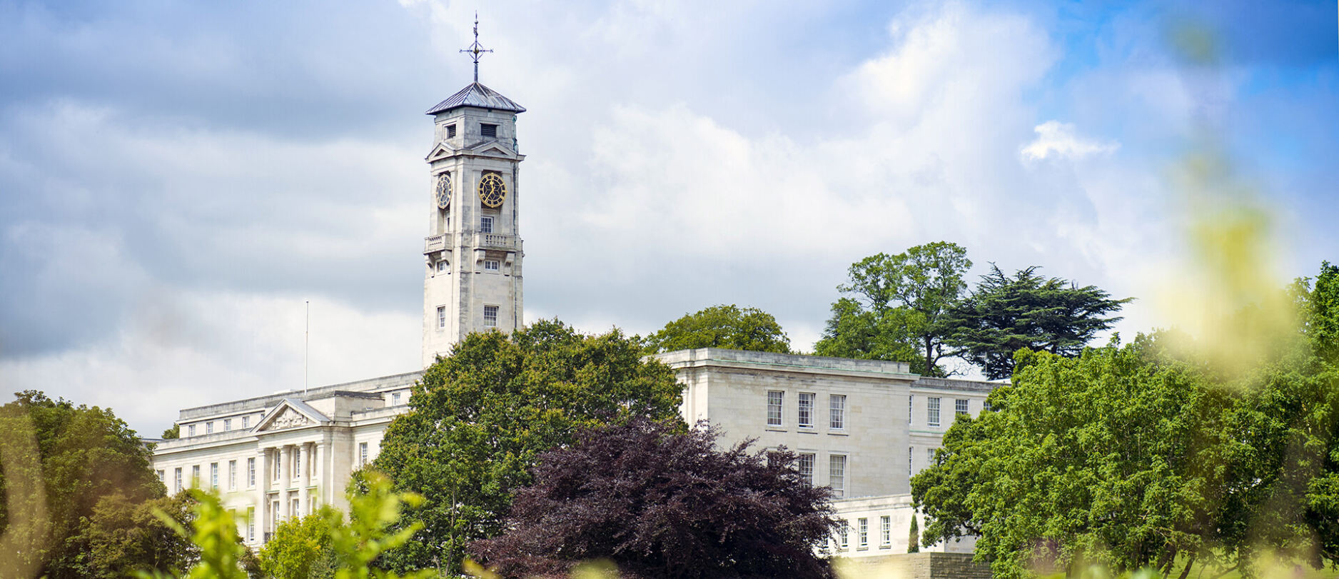 Trent Building with trees in the foreground.