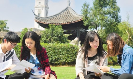 Group of students relaxing and walking in the park, Ningbo Campus, China