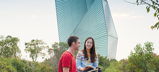 Two undergraduate students studying behind the CSET Building, Ningbo Campus, China