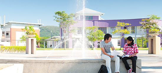 Pair of undergraduate students talking in front of a fountain, Malaysia Campus