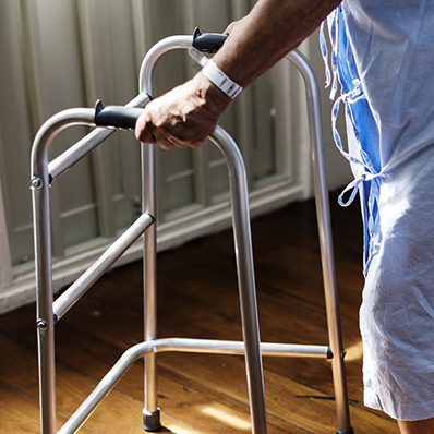patient using assistive walking frame