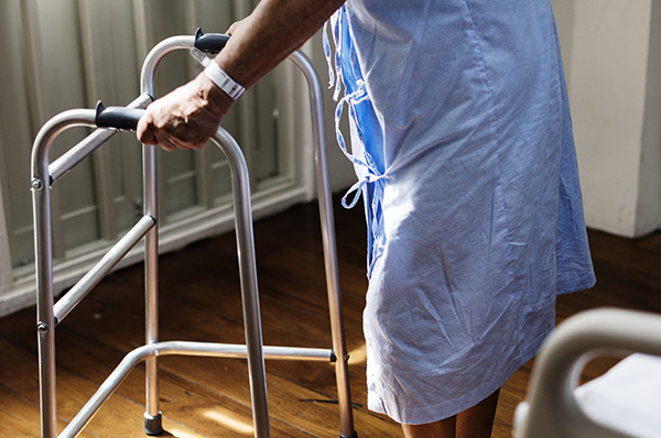 patient using assistive walking frame