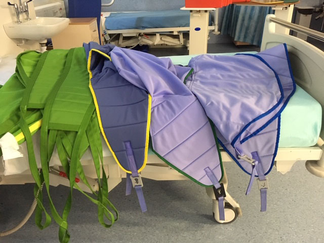 a selection of slings on a hospital bed