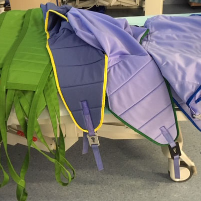 a selection of slings on a hospital bed