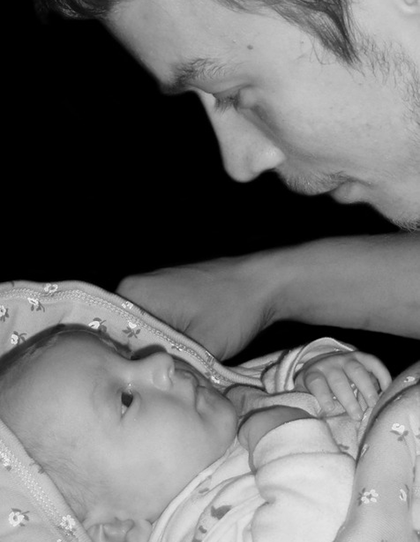 Father and baby looking at one another with love