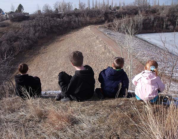 Children looking into a disused mine.