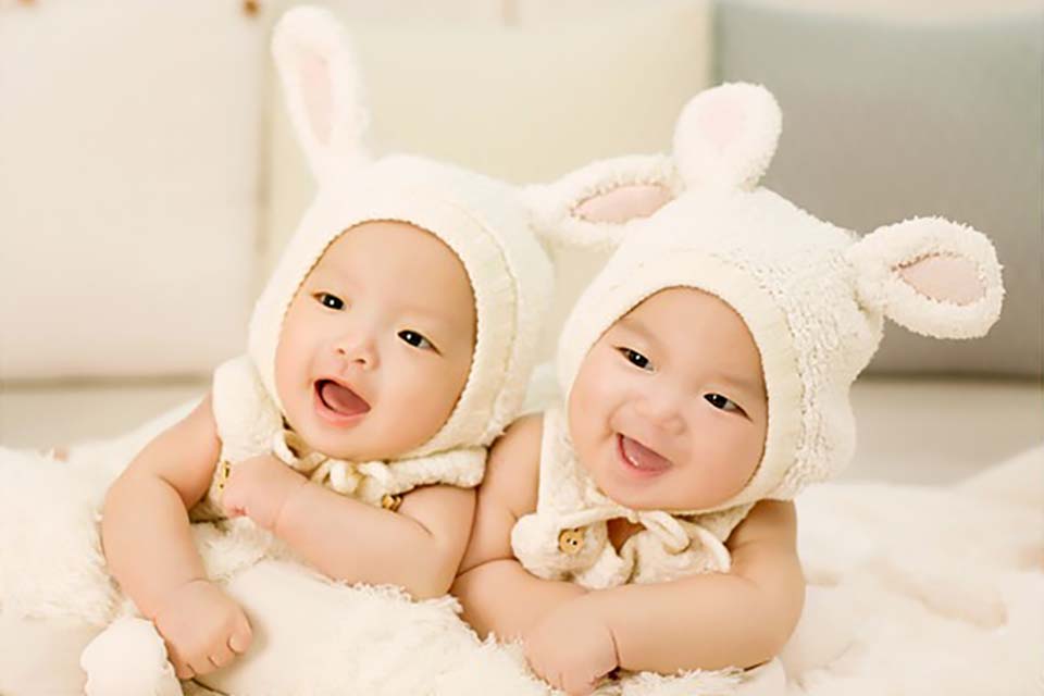 Two Babies Expressing Happiness