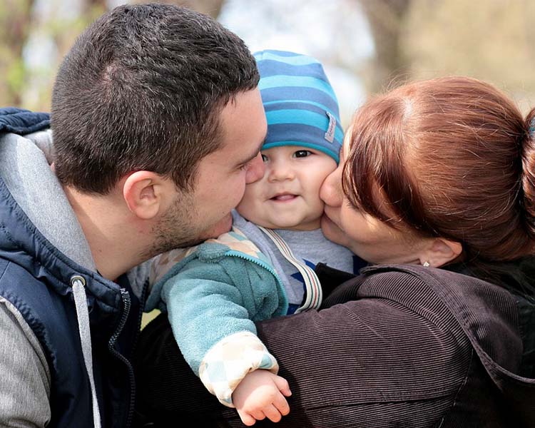 A mother, father and baby