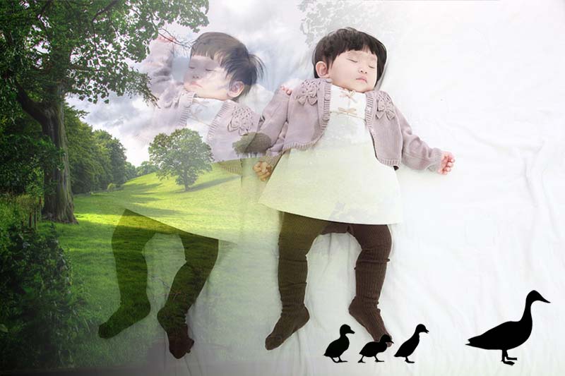 Twins lying on a bed