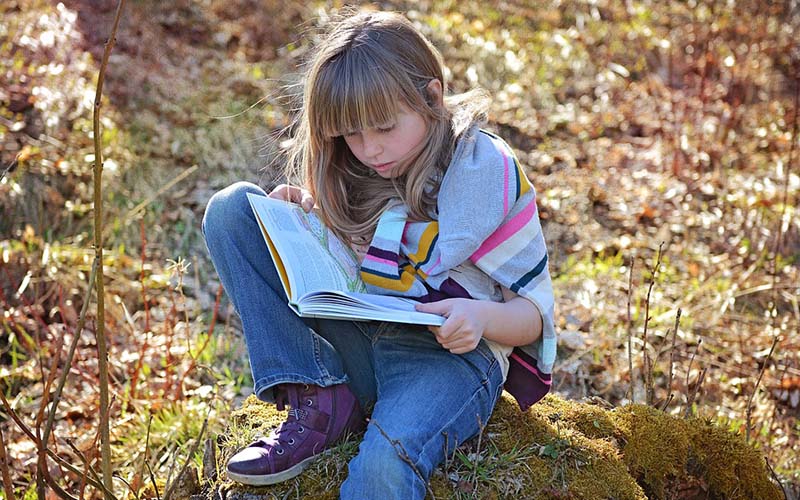 A girl reading in a forest