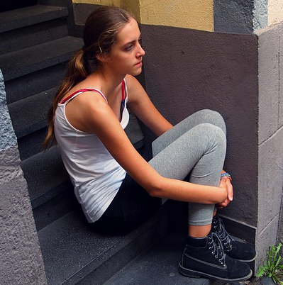 Teenage girl sitting on step