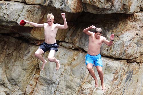 Risk, 2 boys jumping into a river.