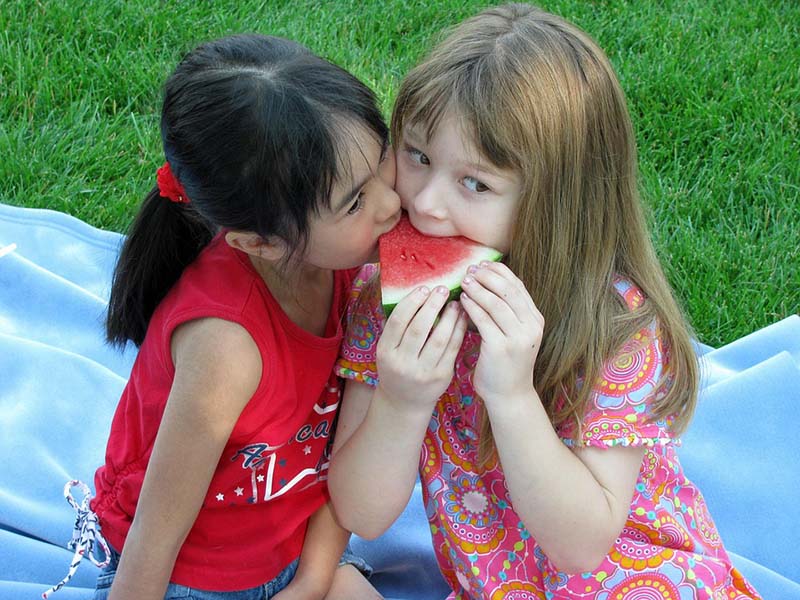 Two girls sharing a water melon