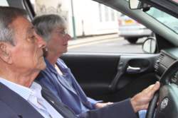 Hearing aid users driving in a car.