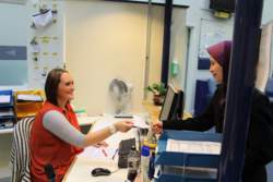 Receptionist providing batteries